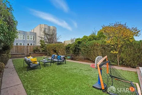 a backyard of a house with table and chairs