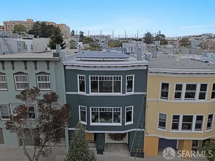 a front view of a building with a garden