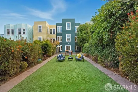 a view of a house with a yard patio and sitting area