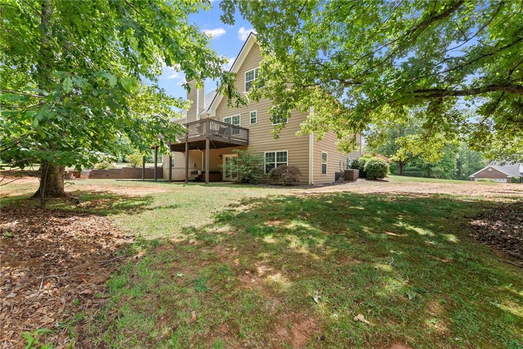 6643 Windvane Point Clermont, GA 30527 - Photo 7 of 88 a view of a house with a big yard and large tree