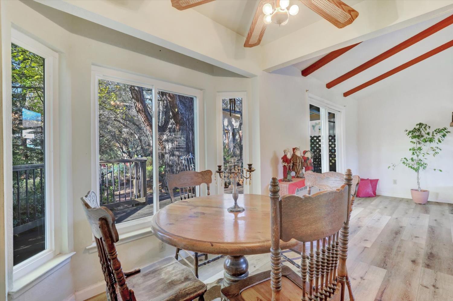 23126 Foothill Road Auburn, CA 95602 - Photo 16 of 63 a dining room with furniture a chandelier and wooden floor
