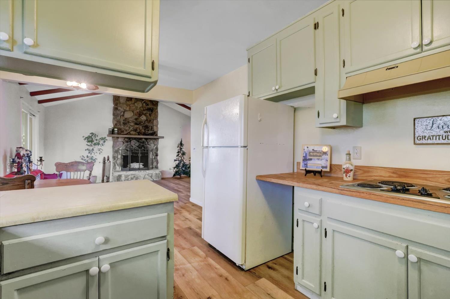 23126 Foothill Road Auburn, CA 95602 - Photo 22 of 63 a kitchen with stainless steel appliances a sink cabinets and wooden floor