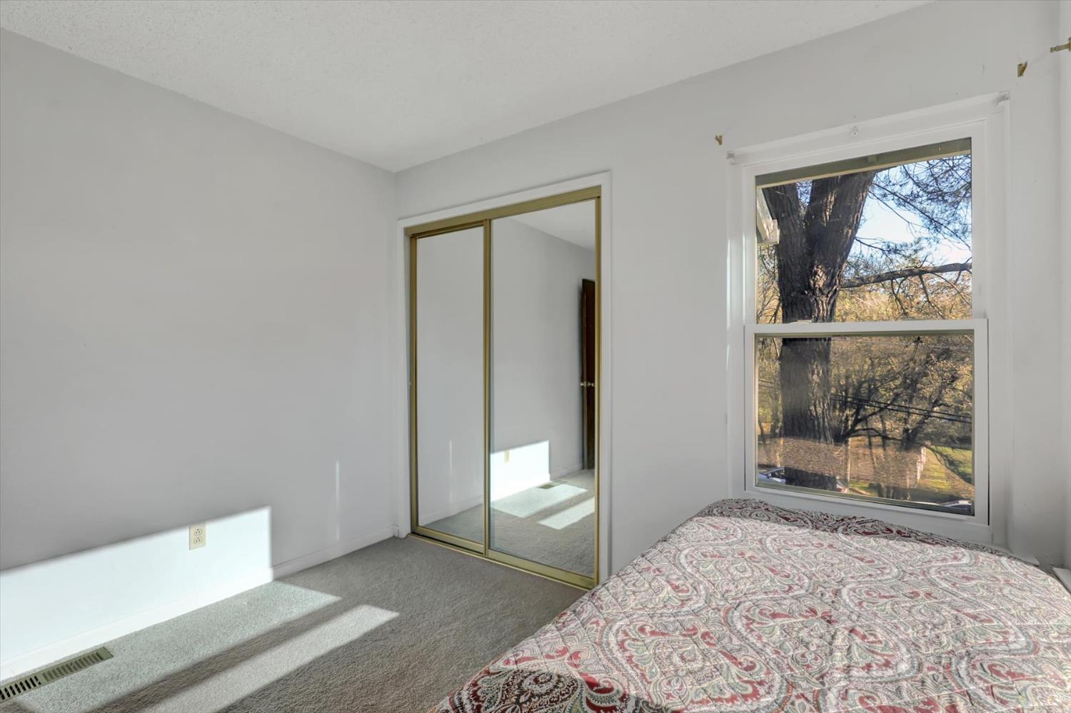 23126 Foothill Road Auburn, CA 95602 - Photo 33 of 63 a bedroom with a bed and a window
