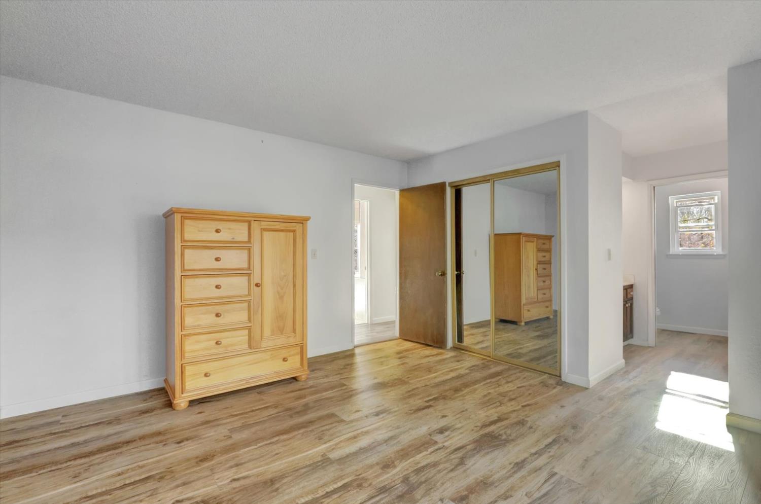 23126 Foothill Road Auburn, CA 95602 - Photo 37 of 63 an empty room with wooden floor closet and windows