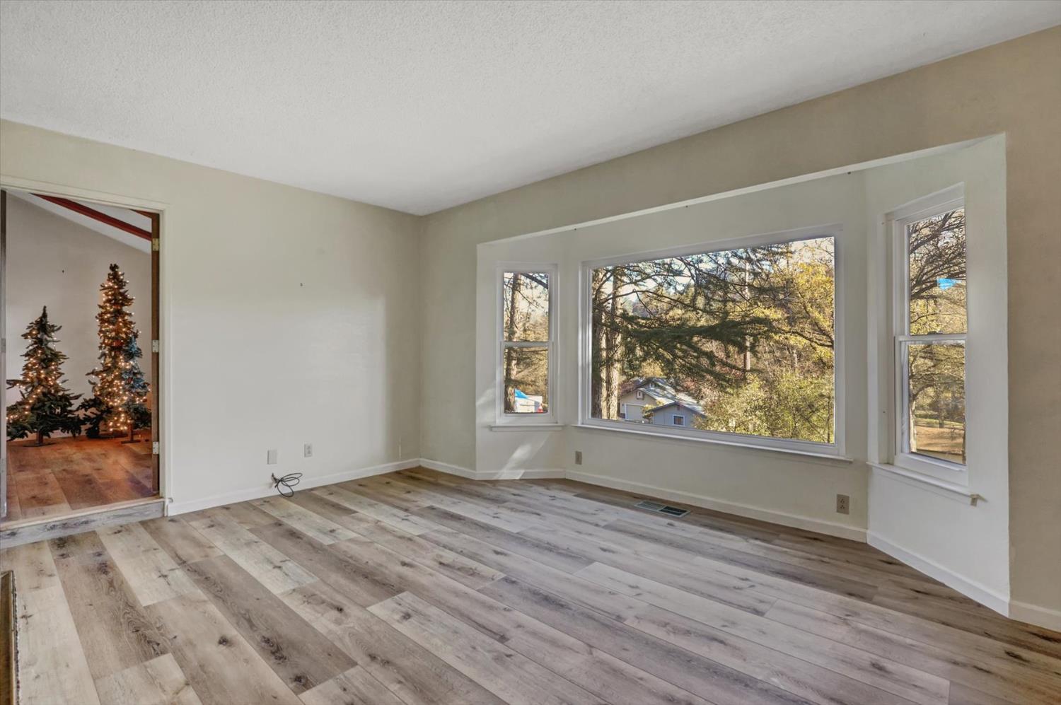 23126 Foothill Road Auburn, CA 95602 - Photo 5 of 63 wooden floor in an empty room with a window