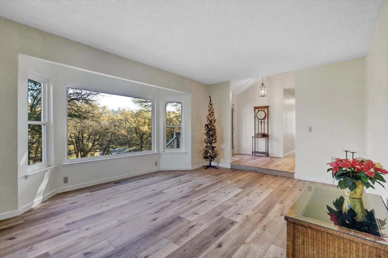 23126 Foothill Road Auburn, CA 95602 - Photo 9 of 63 a view of an empty room with wooden floor and a window