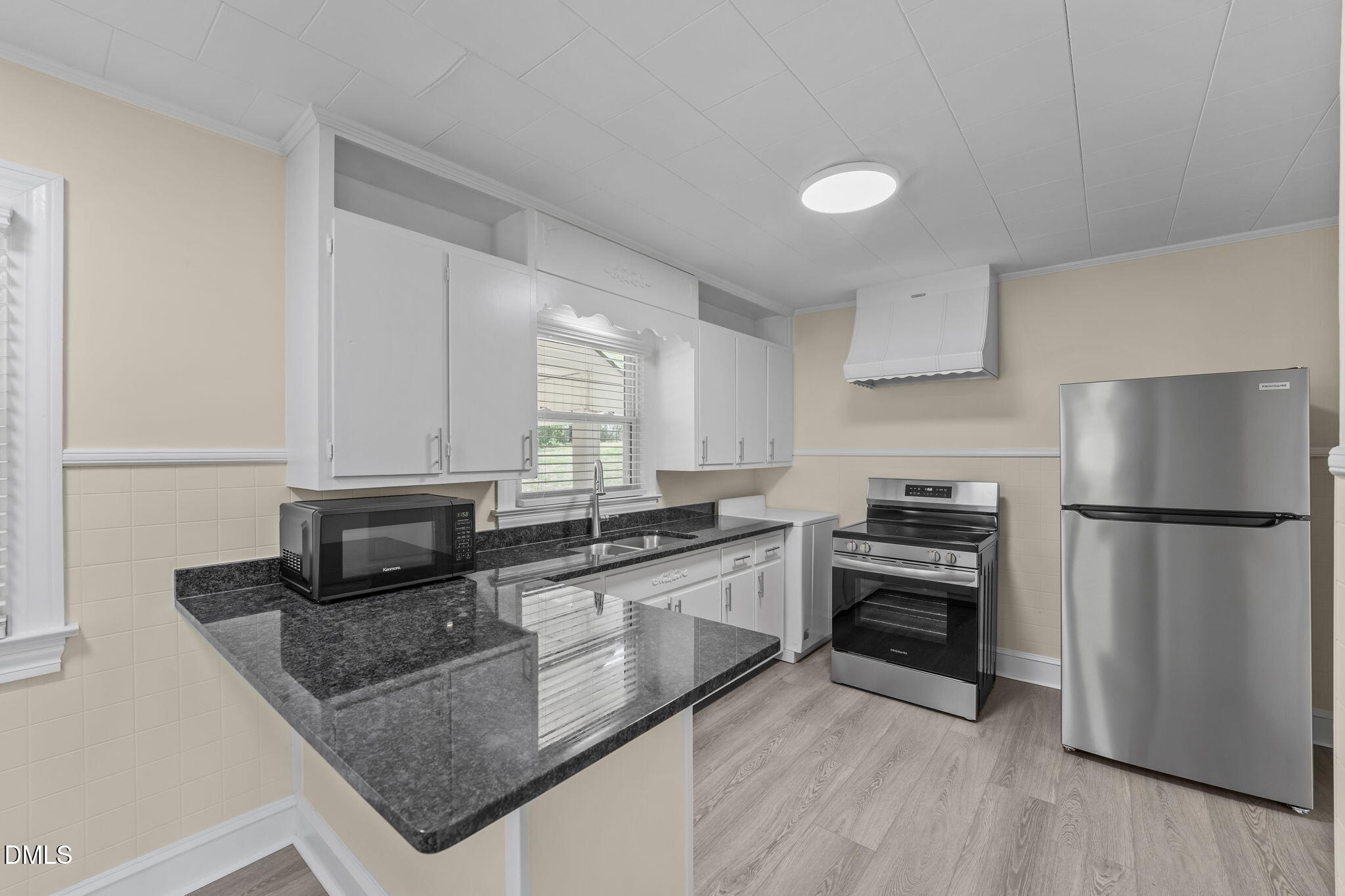 1723 Power Line Road Elon, NC 27244 - Photo 8 of 22 a kitchen with stainless steel appliances granite countertop a stove a sink and a refrigerator