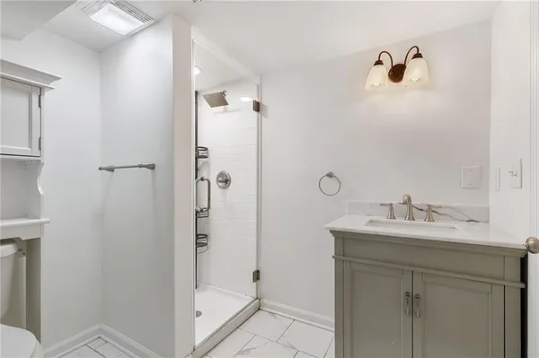 a bathroom with a shower sink and mirror
