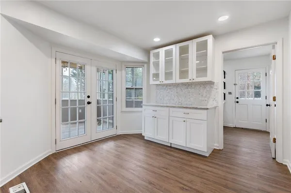 a view of wooden floor and windows in a room