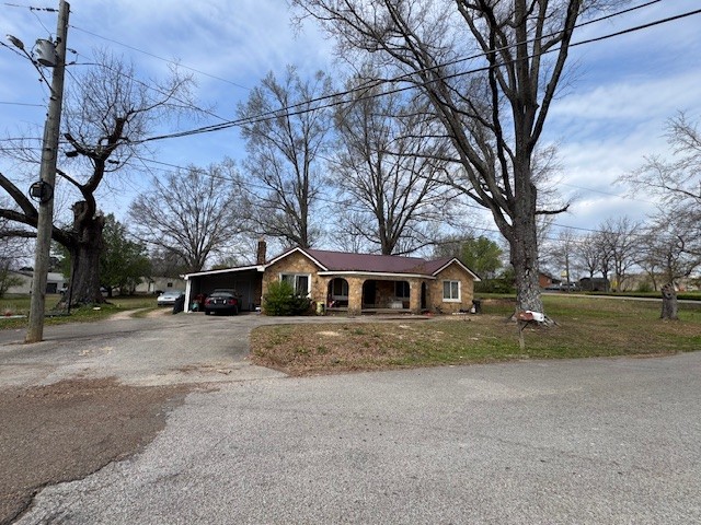 176 Buckner Street Parsons, TN 38363 - Photo 2 of 9 a view of a house with a yard covered in snow