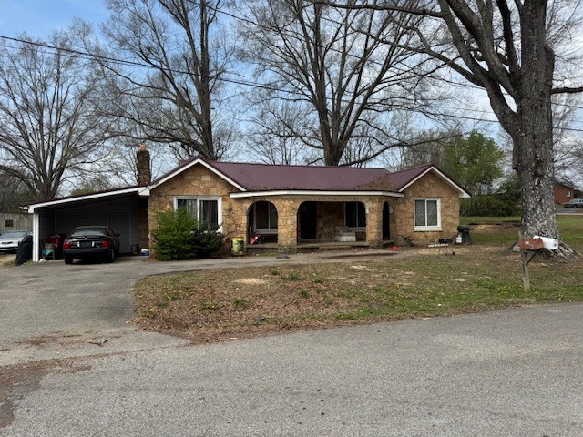 176 Buckner Street Parsons, TN 38363 - Photo 3 of 9 a front view of a house with garage