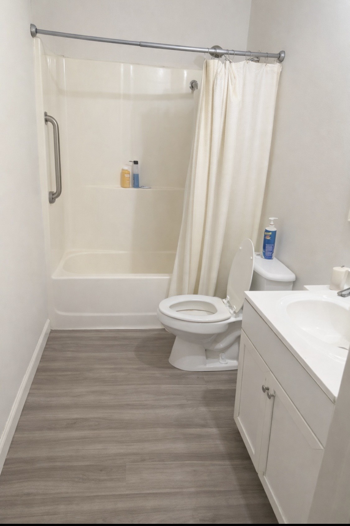 176 Buckner Street Parsons, TN 38363 - Photo 7 of 9 a bathroom with a sink a toilet a shower curtain and a bath tub