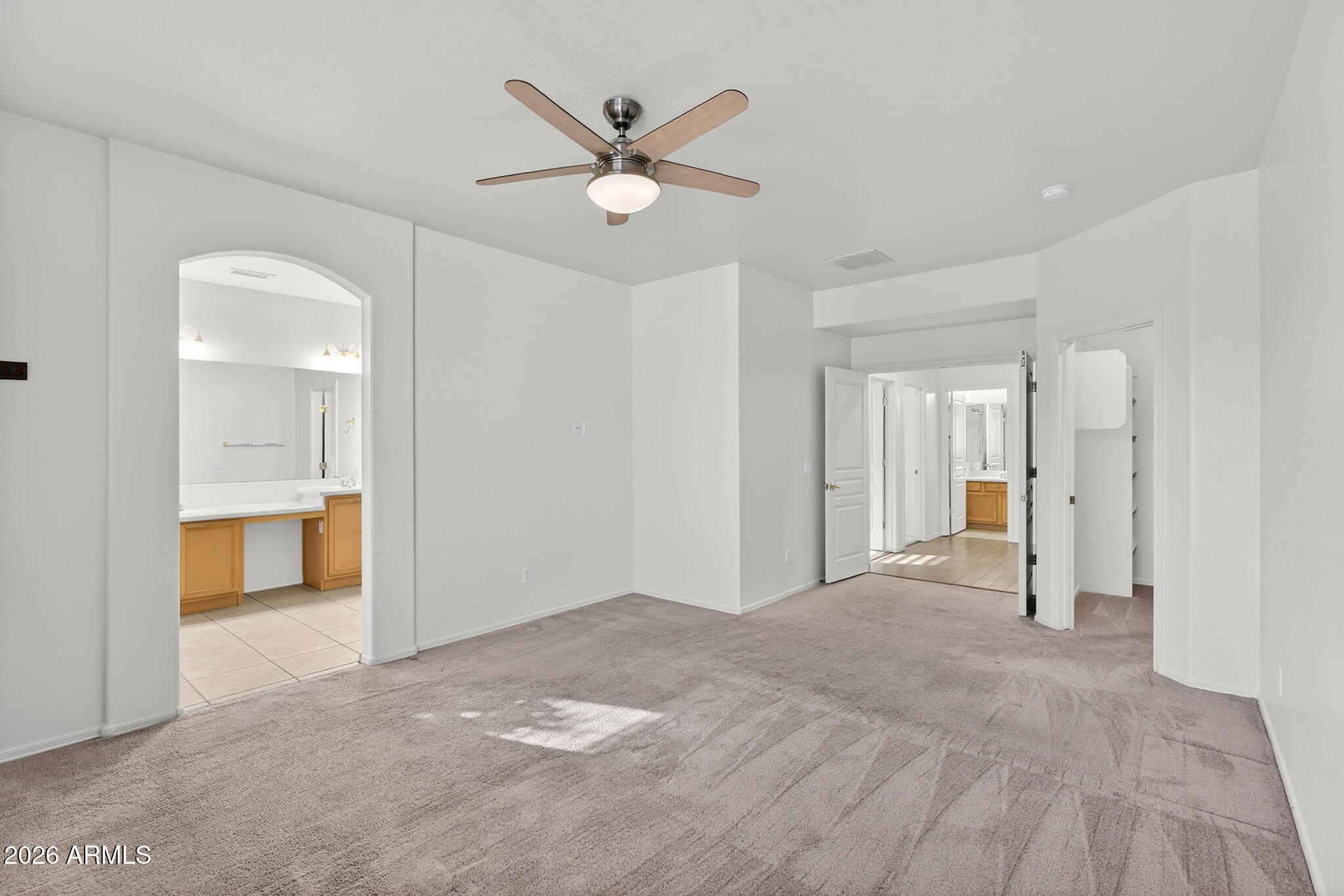 8217 West Bloomfield Road Peoria, AZ 85381 - Photo 16 of 48 a view of a livingroom with a ceiling fan & entryway