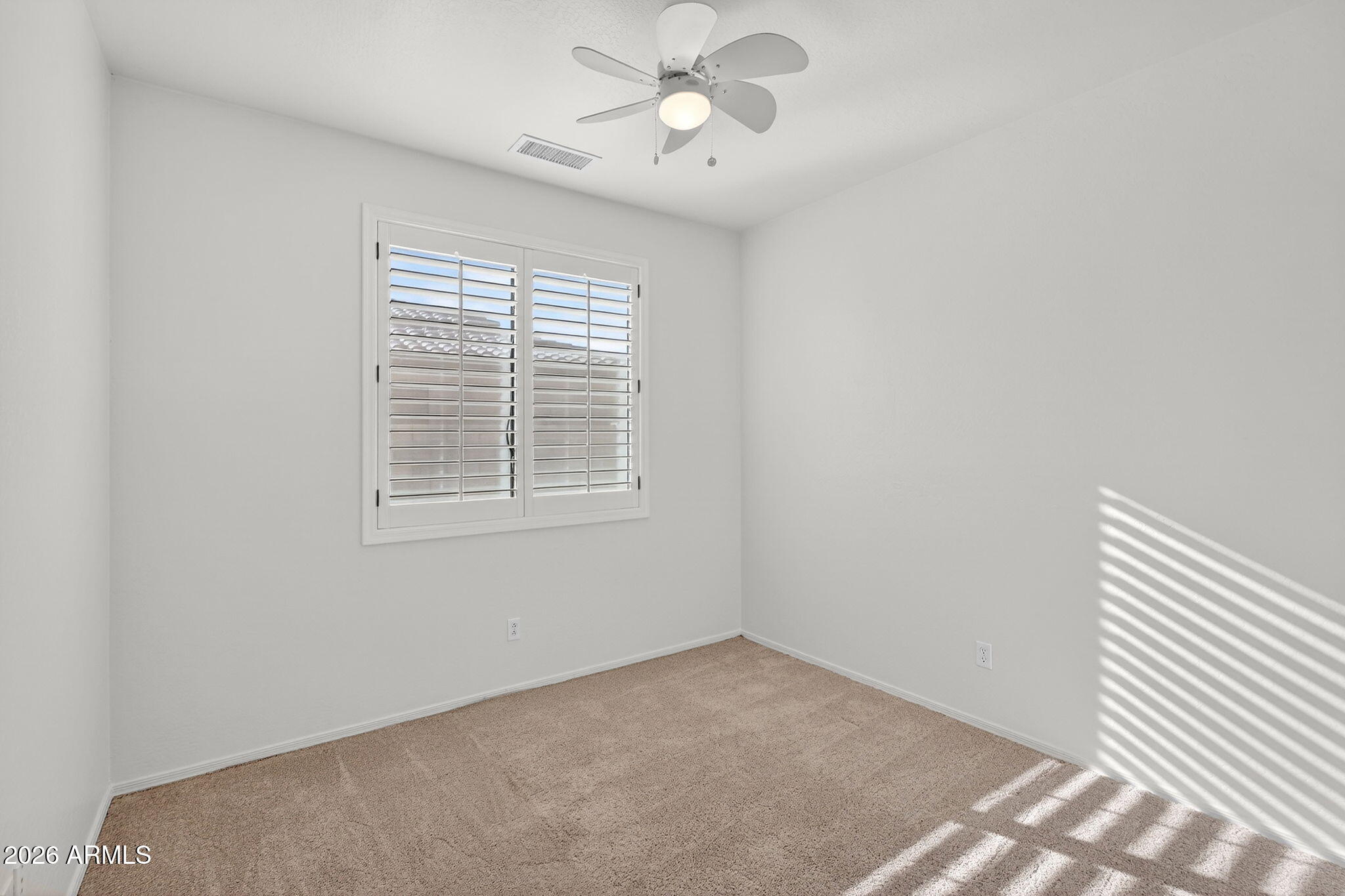 8217 West Bloomfield Road Peoria, AZ 85381 - Photo 26 of 48 an empty room with a window and a fan