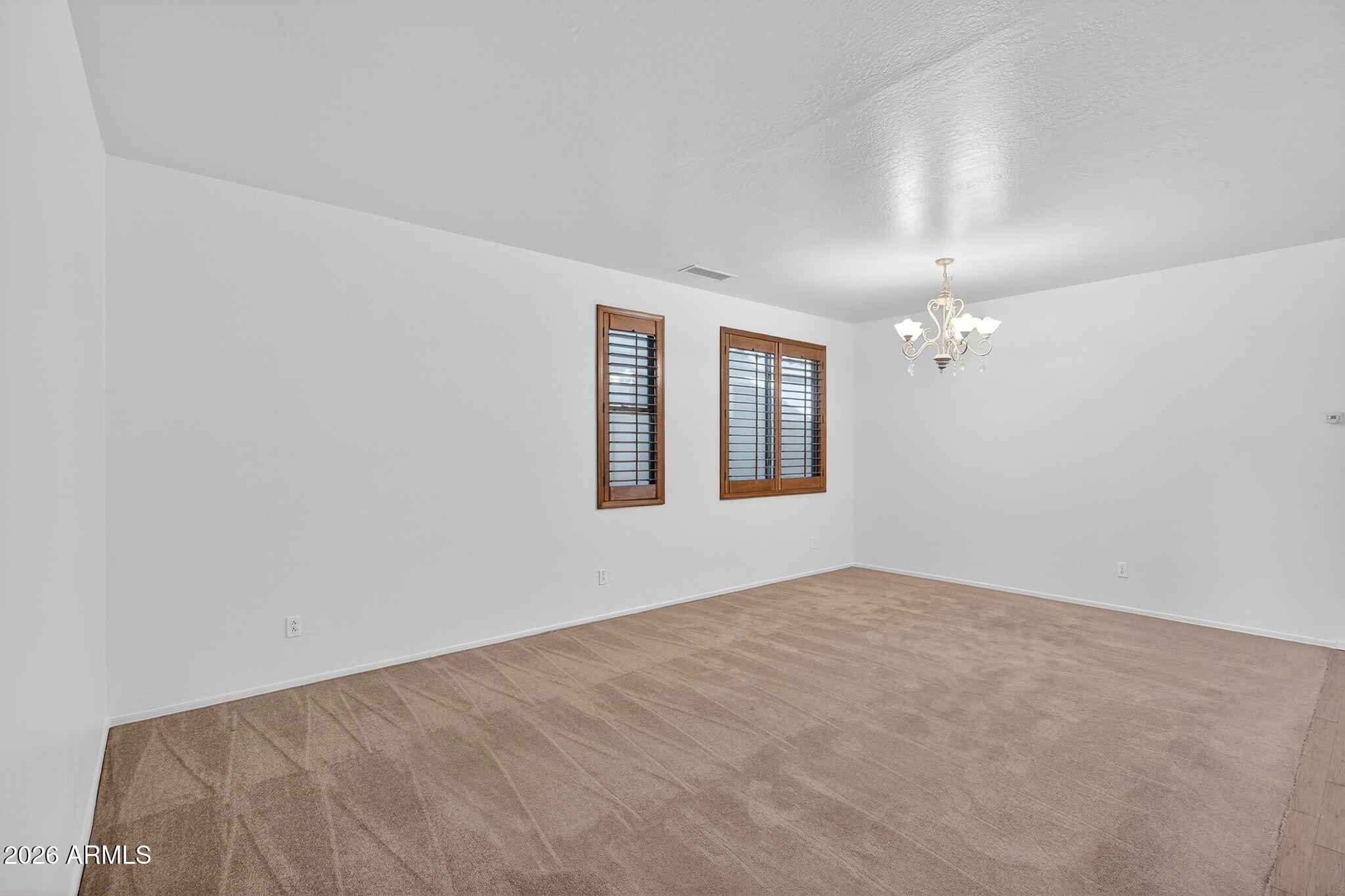 8217 West Bloomfield Road Peoria, AZ 85381 - Photo 5 of 48 an empty room with windows and chandelier fan