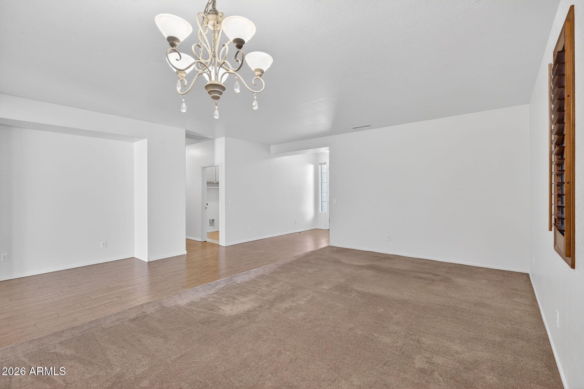 8217 West Bloomfield Road Peoria, AZ 85381 - Photo 6 of 48 a view of an empty room with chandelier fan