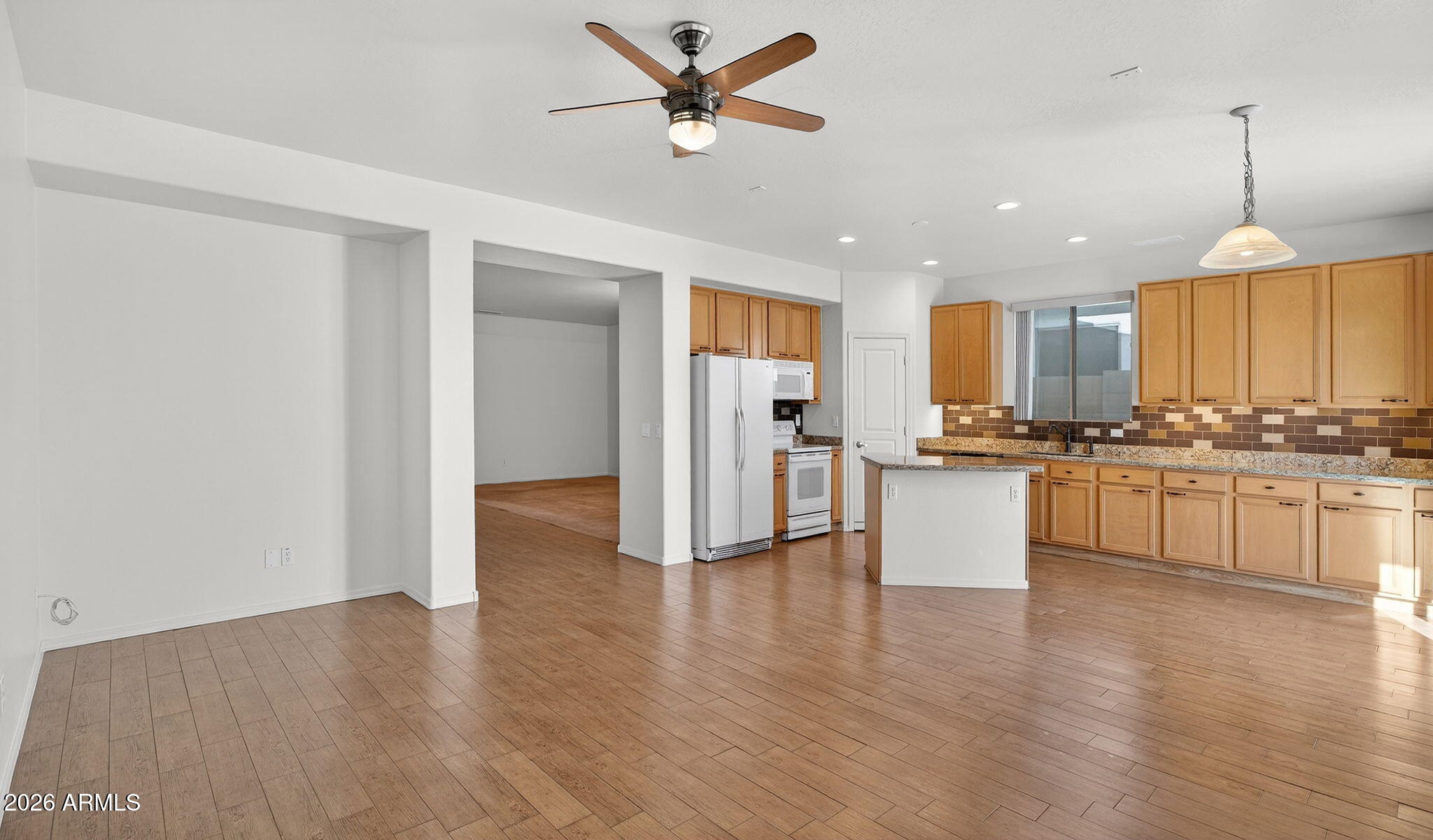 8217 West Bloomfield Road Peoria, AZ 85381 - Photo 8 of 48 a view of kitchen with stainless steel appliances granite countertop cabinets and wooden floor