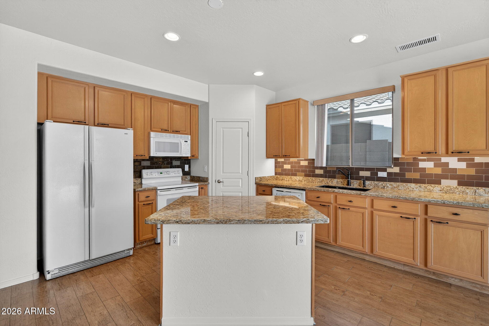 8217 West Bloomfield Road Peoria, AZ 85381 - Photo 9 of 48 a kitchen with stainless steel appliances granite countertop a refrigerator a sink dishwasher a stove with wooden cabinets and floor