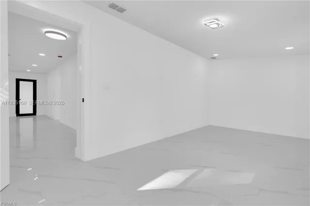 an empty room with white walls and tiles