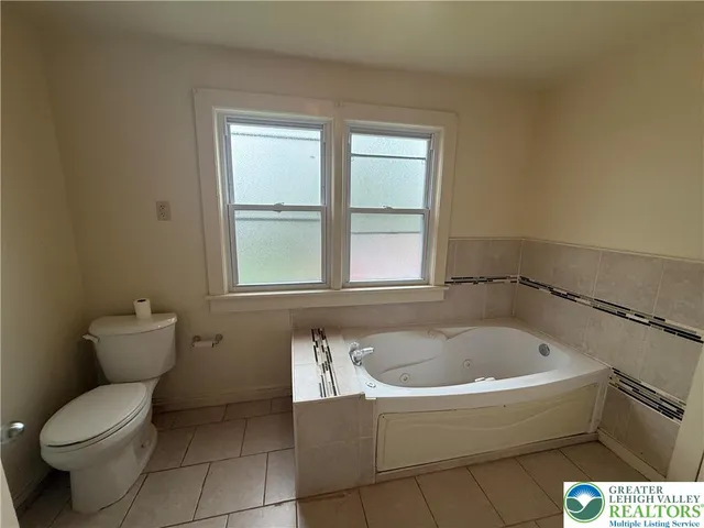 a bathroom with a toilet and a bathtub