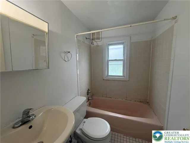 a bathroom with a sink toilet and bathtub