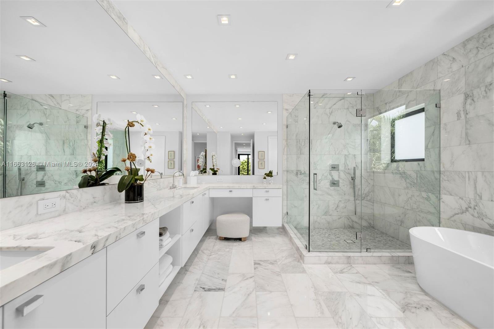 5327 North Bay Road Miami Beach, FL 33140 - Photo 23 of 37 a bathroom with a double vanity sink toilet and shower