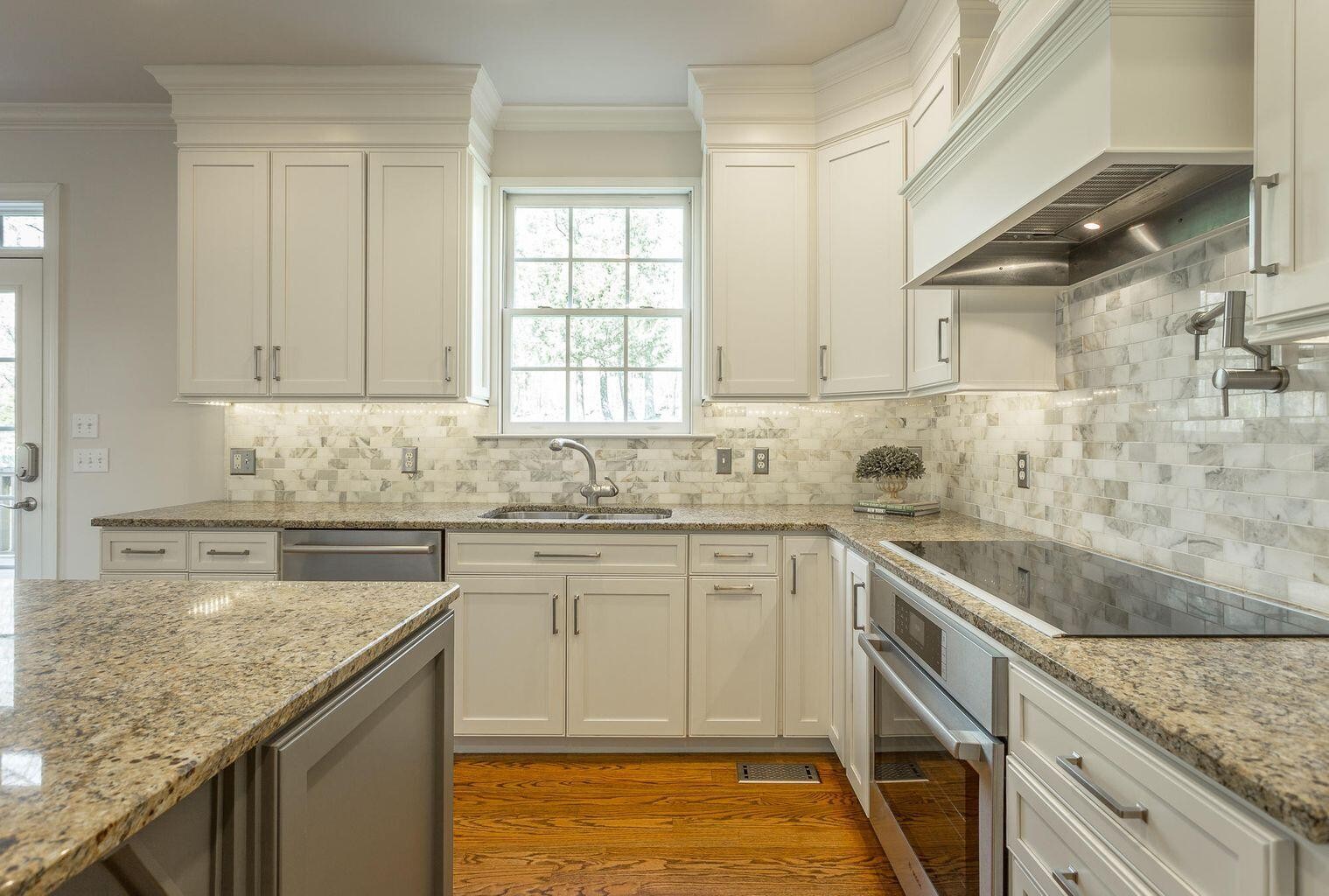 9619 Windrose Circle Chattanooga, TN 37421 - Photo 18 of 69 a kitchen with granite countertop sink stainless steel appliances and a counter space