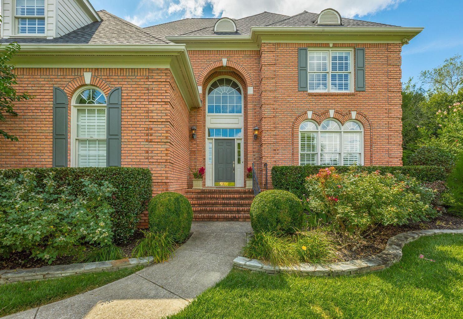 9619 Windrose Circle Chattanooga, TN 37421 - Photo 2 of 69 a front view of a house with garden