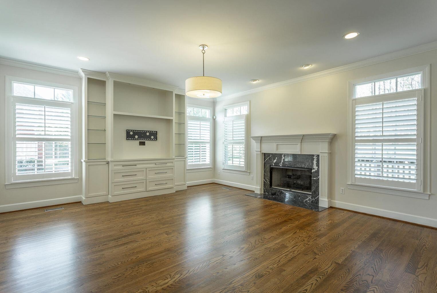 9619 Windrose Circle Chattanooga, TN 37421 - Photo 25 of 69 an empty room with windows fireplace and wooden floor