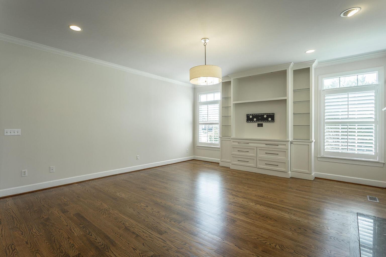 9619 Windrose Circle Chattanooga, TN 37421 - Photo 26 of 69 an empty room with wooden floor chandelier and windows