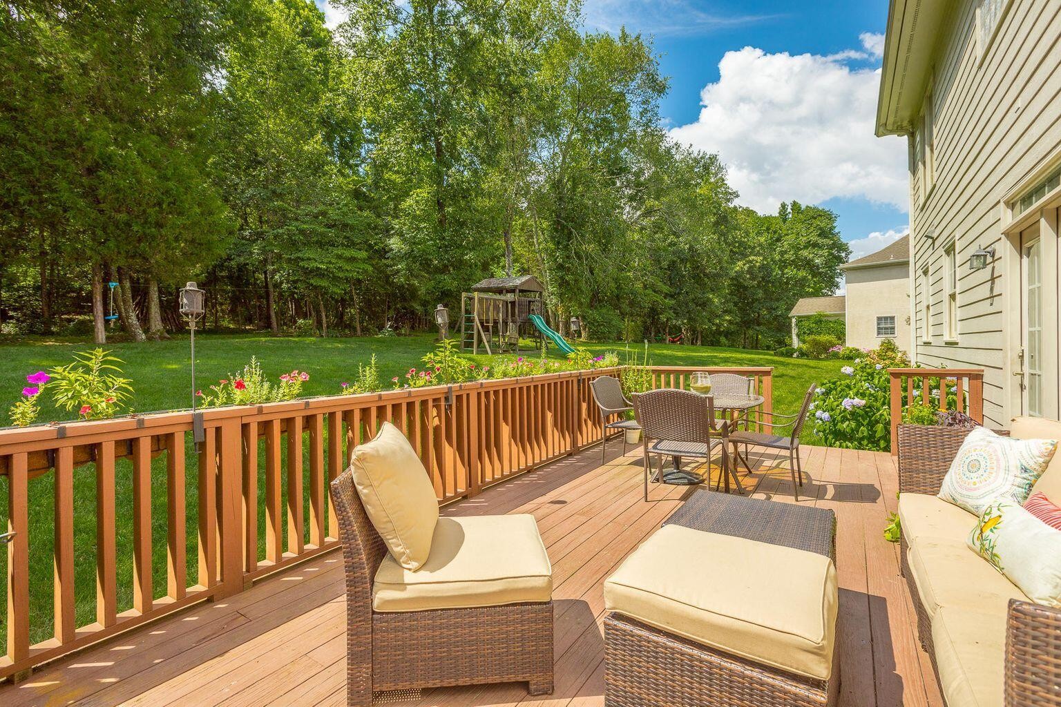 9619 Windrose Circle Chattanooga, TN 37421 - Photo 56 of 69 a view of a patio with couches chairs potted plants and a palm tree