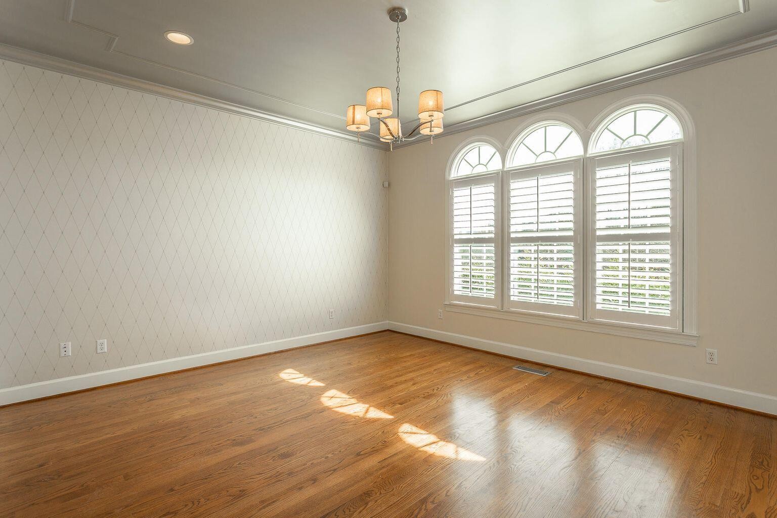 9619 Windrose Circle Chattanooga, TN 37421 - Photo 7 of 69 an empty room with wooden floor chandelier and windows