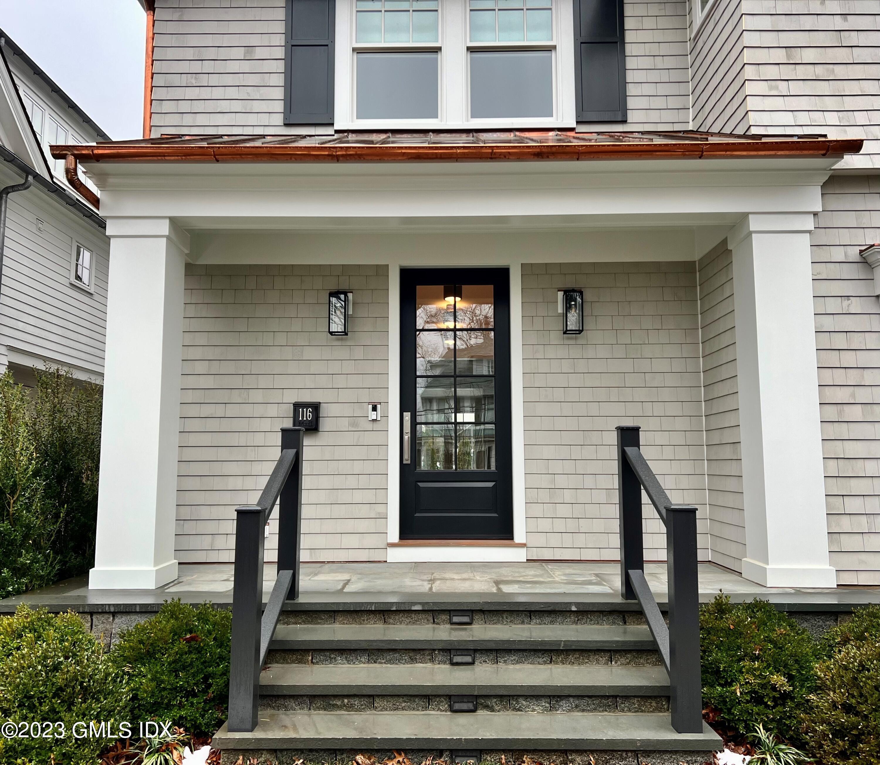 a front view of a house with stairs