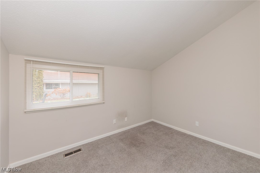 2406 Call Road Stow, OH 44224 - Photo 4 of 30 Carpeted spare room with lofted ceiling
