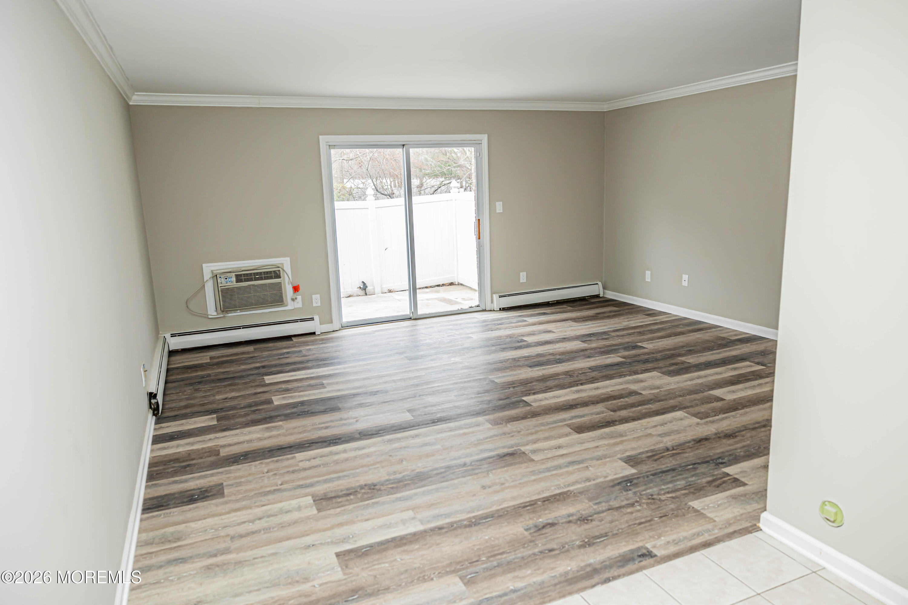 18 Windsor Terrace, Unit 18 Freehold, NJ 07728 - Photo 11 of 37 a view of an empty room with wooden floor and a window