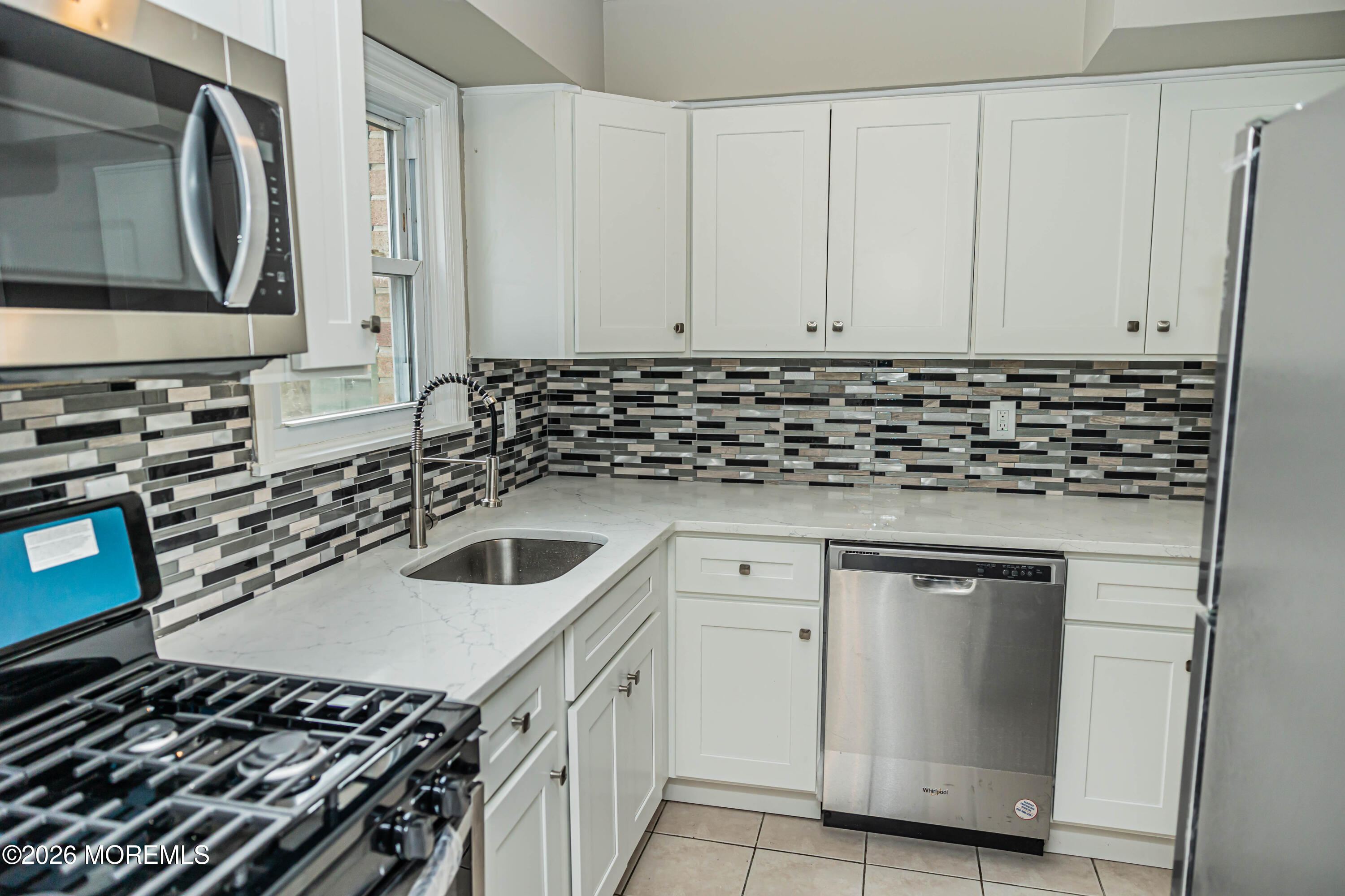 18 Windsor Terrace, Unit 18 Freehold, NJ 07728 - Photo 3 of 37 a kitchen with a sink stove and cabinets