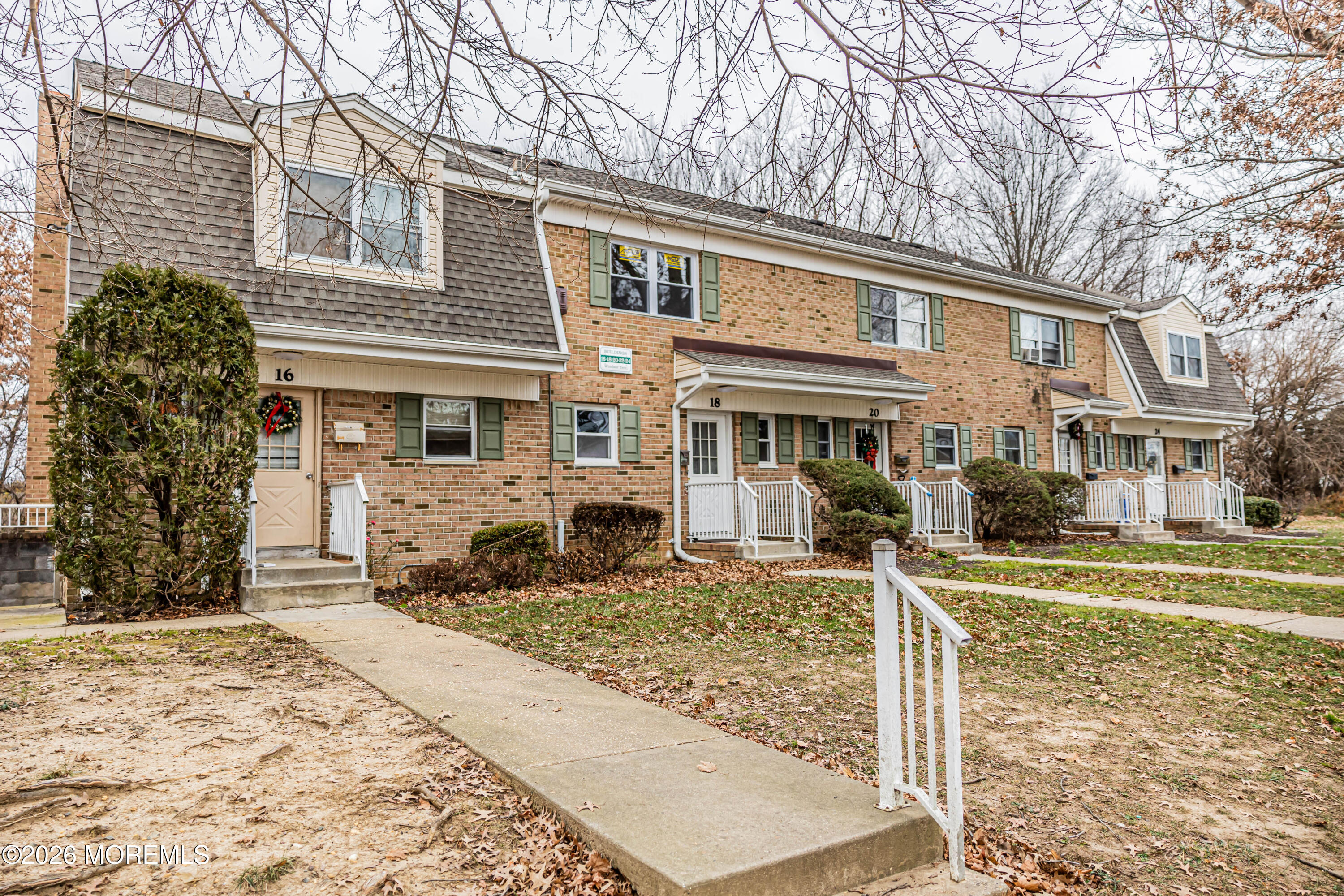 18 Windsor Terrace, Unit 18 Freehold, NJ 07728 - Photo 36 of 37 a front view of a house with a yard covered with snow