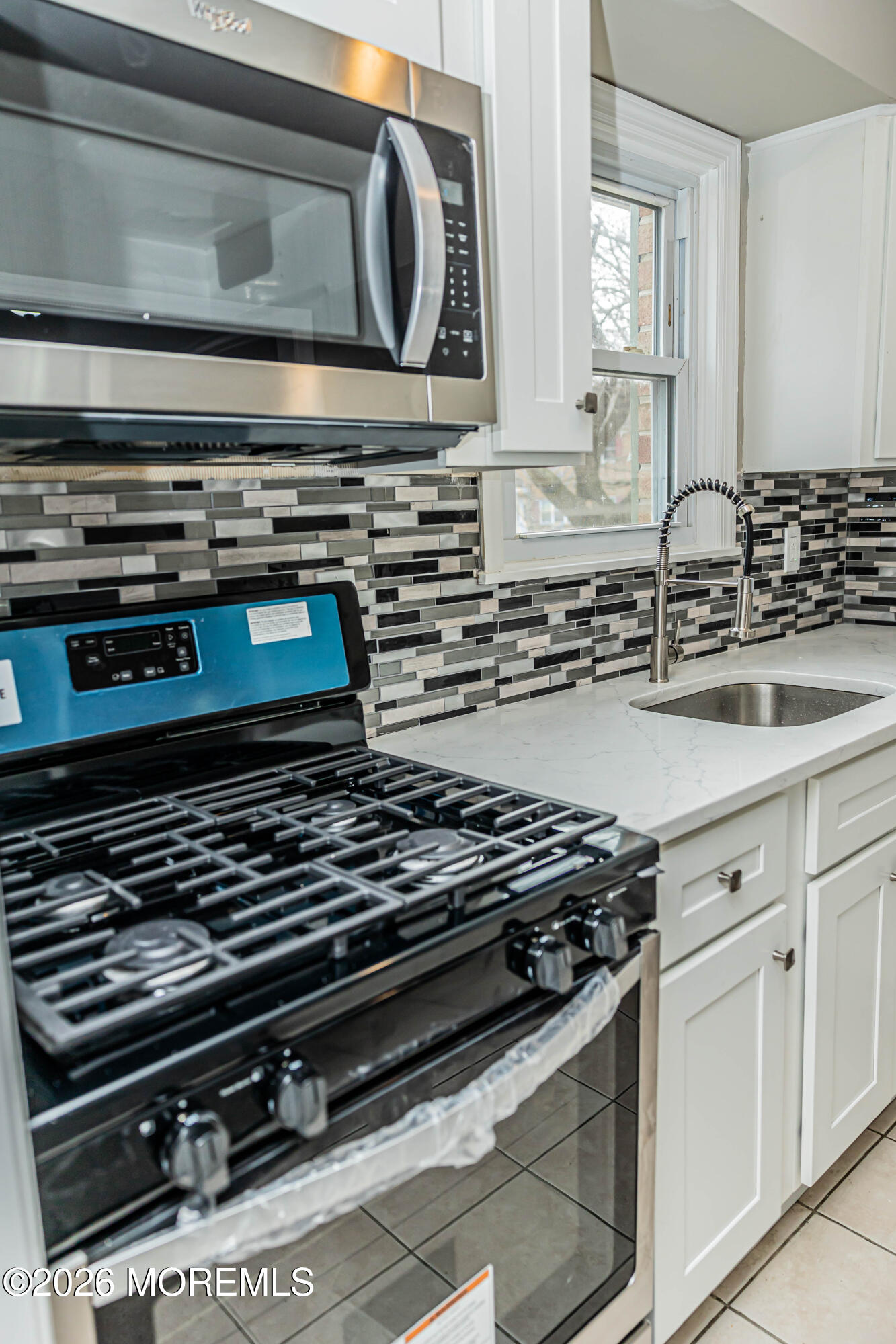 18 Windsor Terrace, Unit 18 Freehold, NJ 07728 - Photo 6 of 37 a stove top oven sitting inside of a kitchen
