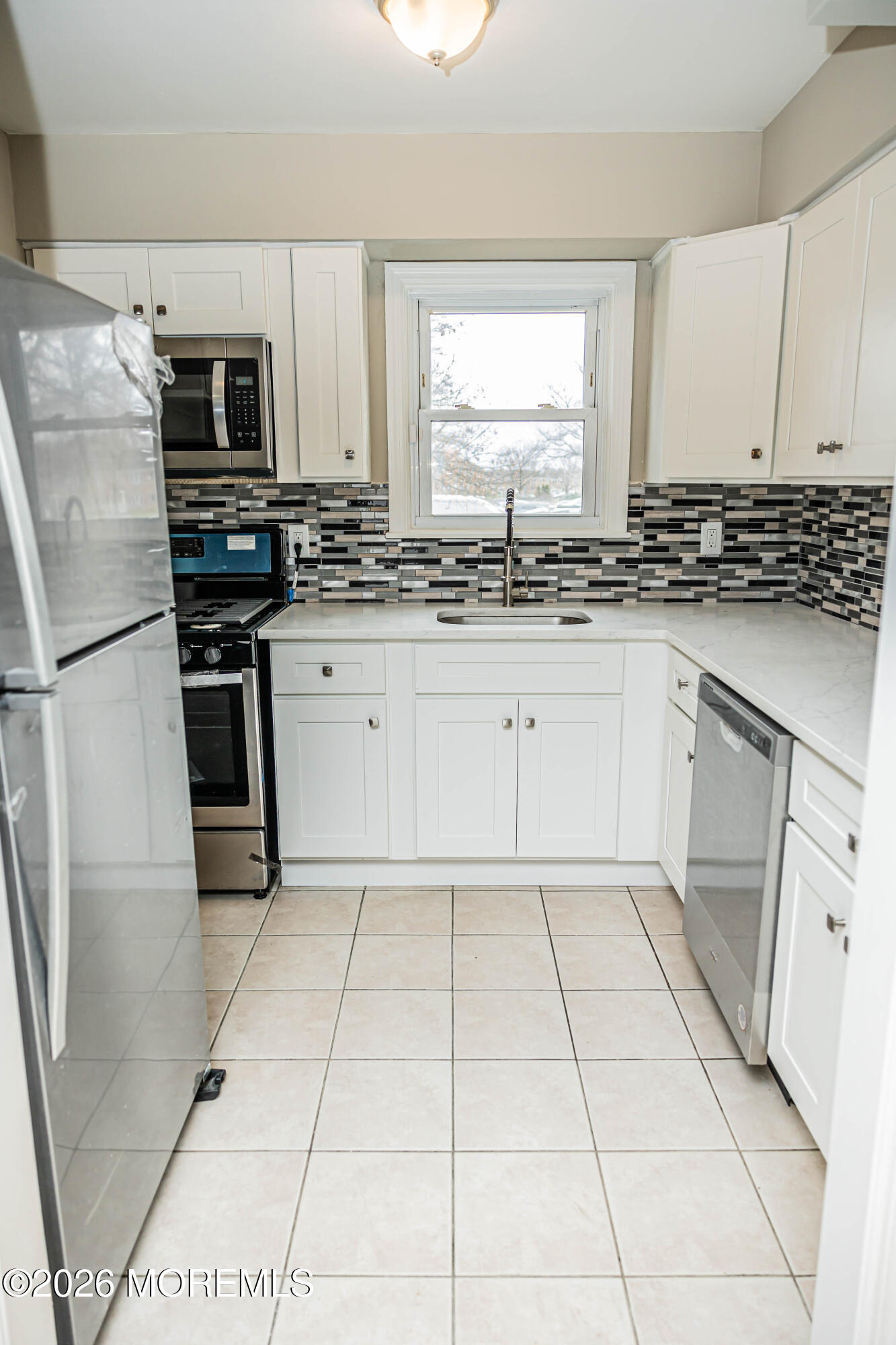 18 Windsor Terrace, Unit 18 Freehold, NJ 07728 - Photo 7 of 37 a kitchen with stainless steel appliances granite countertop a stove a sink and a refrigerator