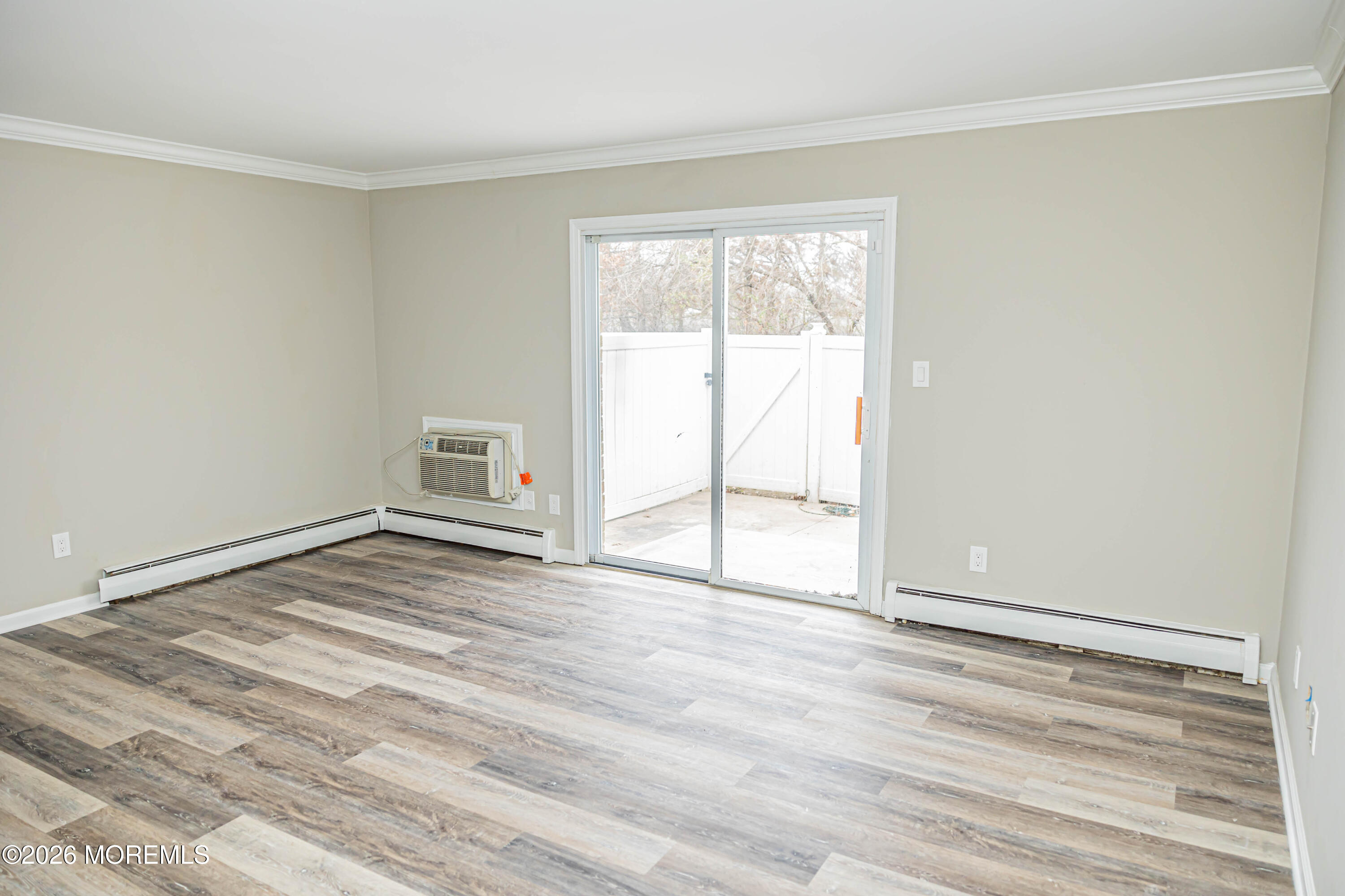 18 Windsor Terrace, Unit 18 Freehold, NJ 07728 - Photo 10 of 37 a view of an empty room with wooden floor and a window