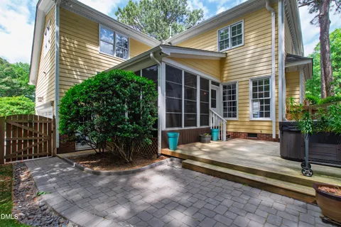 an aerial view of a house with a yard and lake view