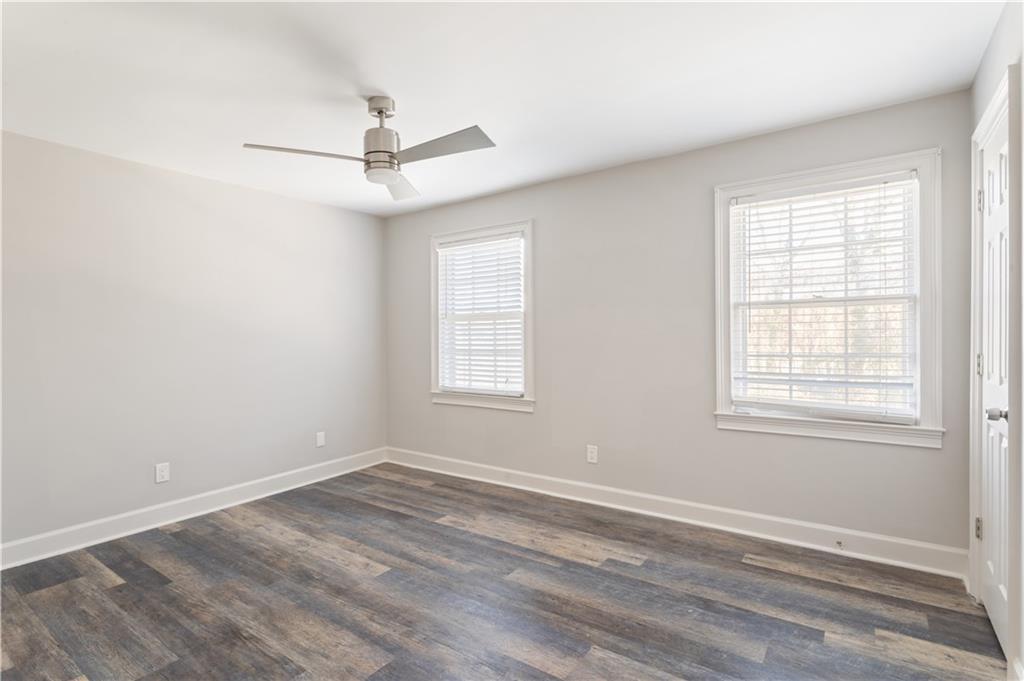 6700 Roswell Road, Unit 23A Atlanta, GA 30328 - Photo 12 of 18 an empty room with a window and a ceiling fan