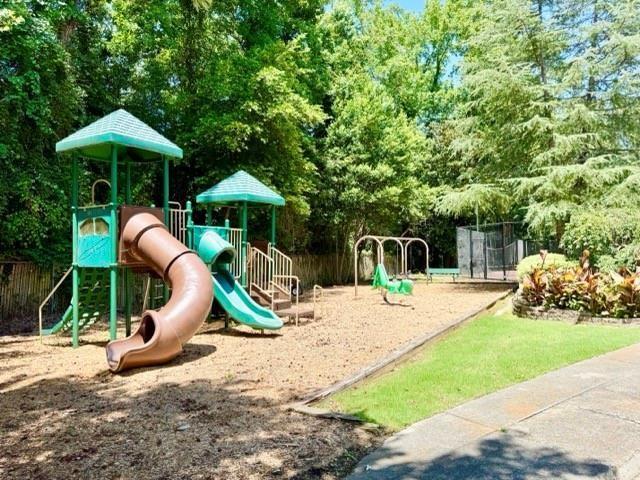 6700 Roswell Road, Unit 23A Atlanta, GA 30328 - Photo 17 of 18 a view of a playground with a slide and swing