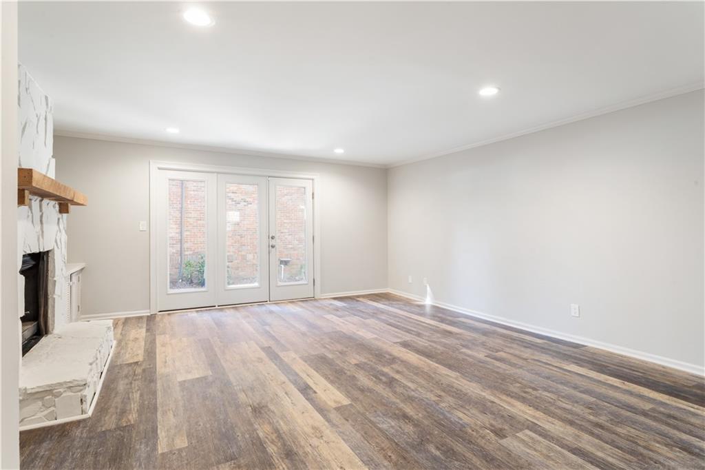 6700 Roswell Road, Unit 23A Atlanta, GA 30328 - Photo 8 of 18 a view of an empty room with wooden floor and a window