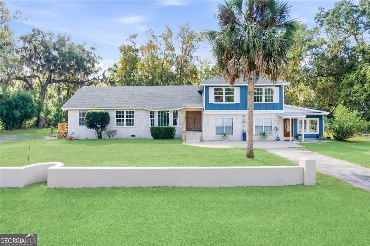a front view of a house with a yard table and chairs