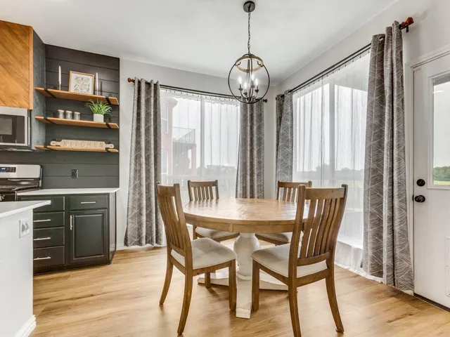 a view of a dining room with furniture large window and wooden floor