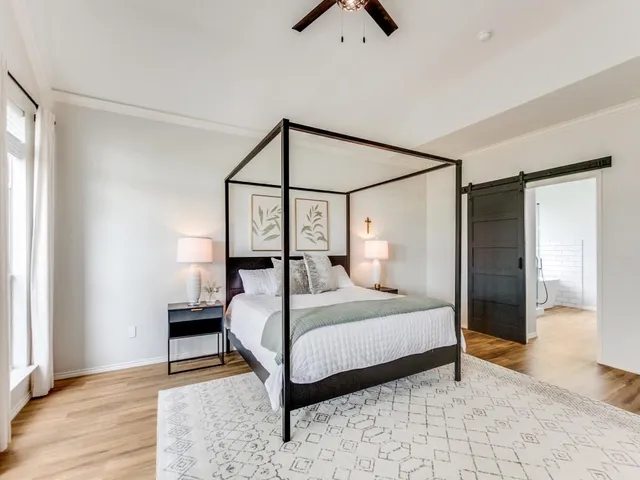a bedroom with a bed and a chandelier
