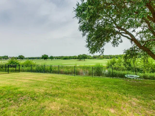 a view of a chairs and table in backyard of the house