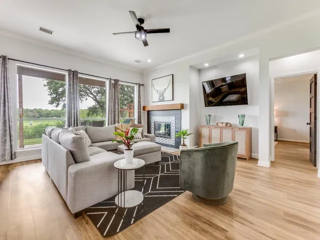 a living room with fireplace furniture and a flat screen tv