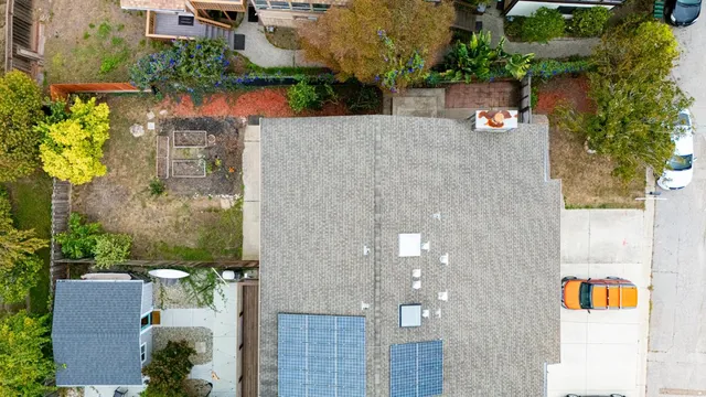 an aerial view of a house with a yard and a fountain